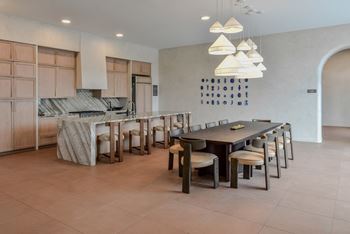 A modern kitchen with a dining table and chairs.